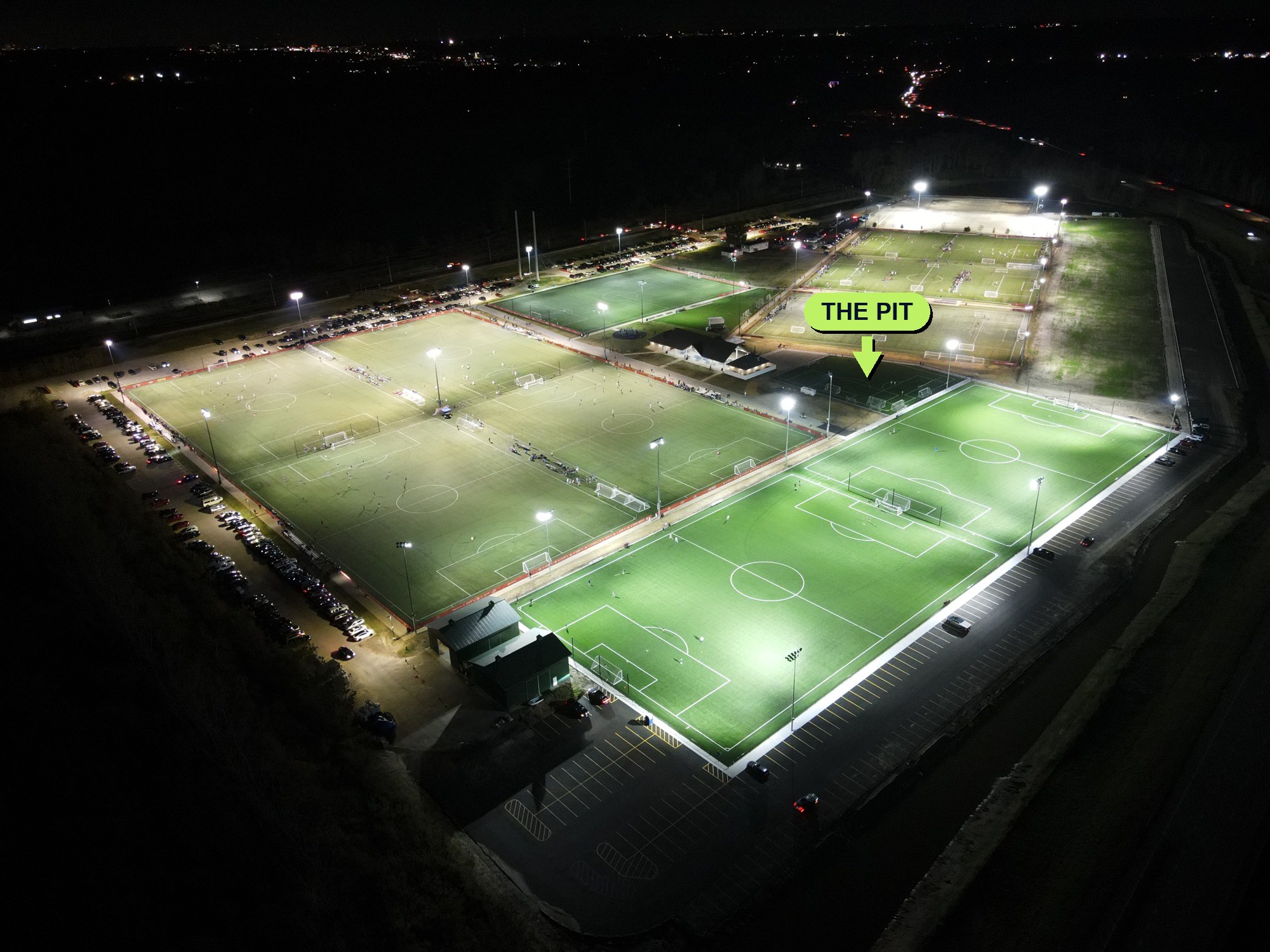 Lou Fusz Athletic Complex at night — aerial view with The Pit training field marked, next to Field 1 and Backpost